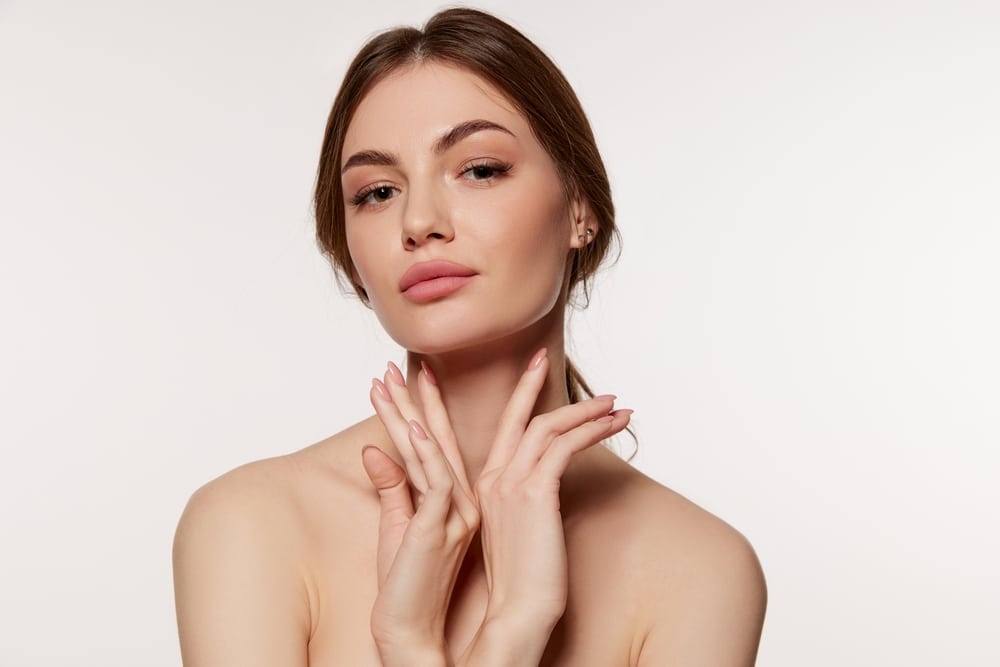 Portrait of young beautiful woman with perfect smooth skin isolated over white background.